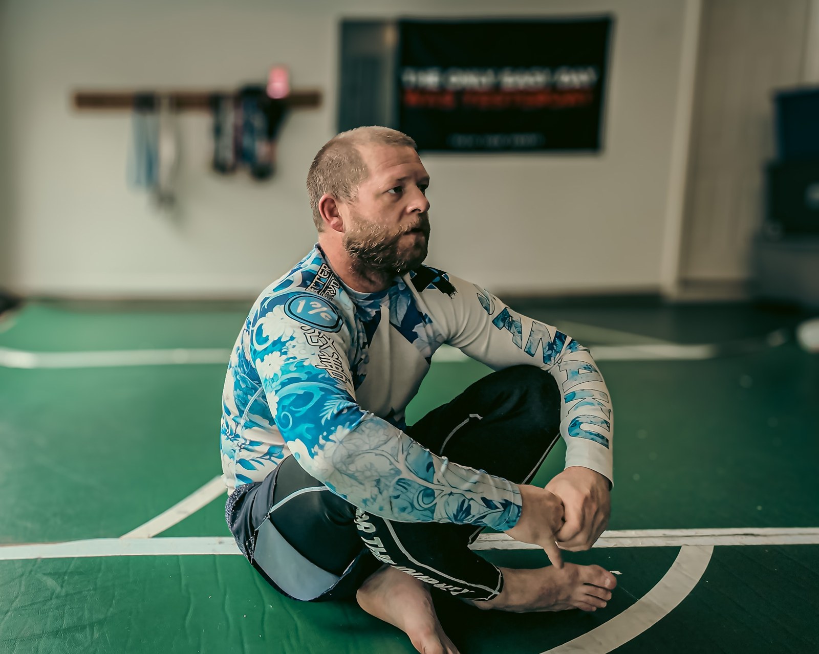Zac Haddock, founder, seated at a jiu-jitsu gym